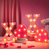 VIHOSE XOXO pink glitter letters illuminate a romantic table setting