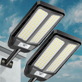 VOOJOY solar street light in dusk-to-dawn mode lights a parking lot.