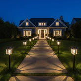 XMCOSY+ solar pathway light in bronze-wood finish lights the front yard with warm security.