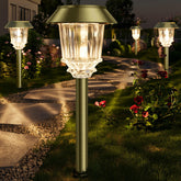XMCOSY+ bronze outdoor solar pathway lights illuminating a stone path at dusk