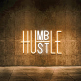 YIKBIK Hustle neon sign in yellow and white adds modern wall decor with warm glow.