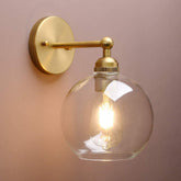 Yosoan brass boho vanity light with glass shade, ideal above bathroom mirrors.