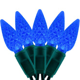 YULETIME blue C6 strawberry LED bulbs illuminate outdoor decor with a vivid glow.