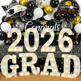 ZOMPAKER Grad marquee letters on table create warm graduation ambiance.