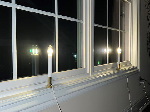 Pack of four candles provides a coordinated glow across windows.