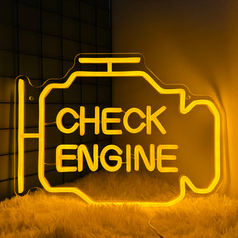 Abooly Check Engine Light Neon Sign mounted above a workbench with warm yellow glow for garage ambiance
