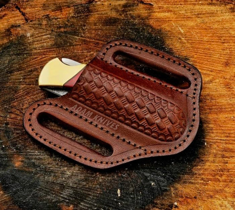 ADAM KNIVES leather sheath with slanted design for secure belt carry.