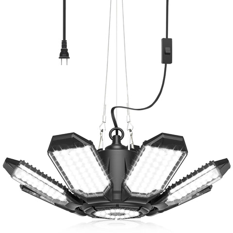 AGranTOP garage light with built-in outlet for convenient power in a workspace.