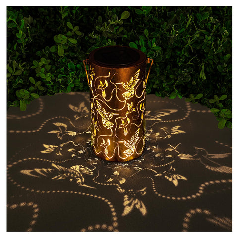 AITENISEN solar lantern with hummingbird decor lights outdoor spaces at dusk.