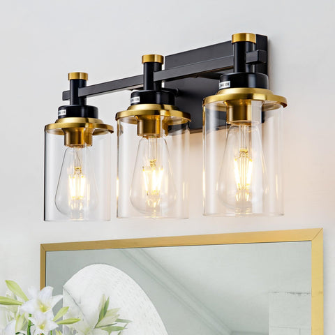 Aixialin 3-light vanity fixture in black and brushed gold with clear glass shade for mirror illumination