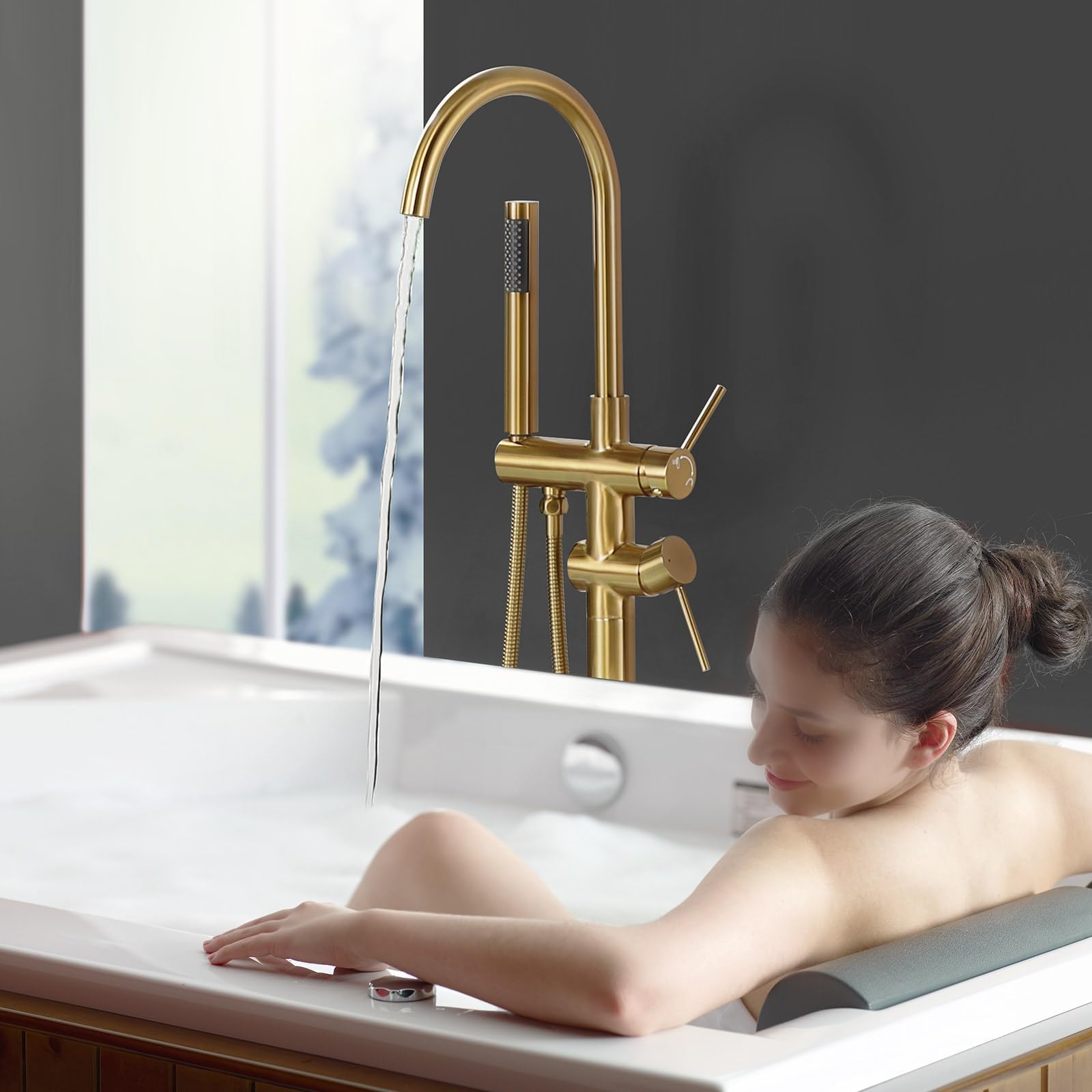 ALEASHA tub filler diverter in brushed gold switches between tub and shower.