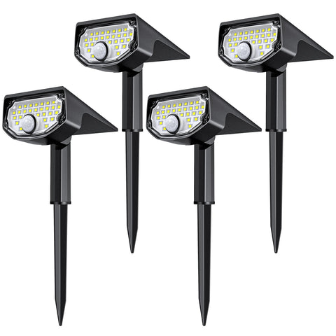AloftSun pack of solar motion sensor lights illuminating a yard at night.