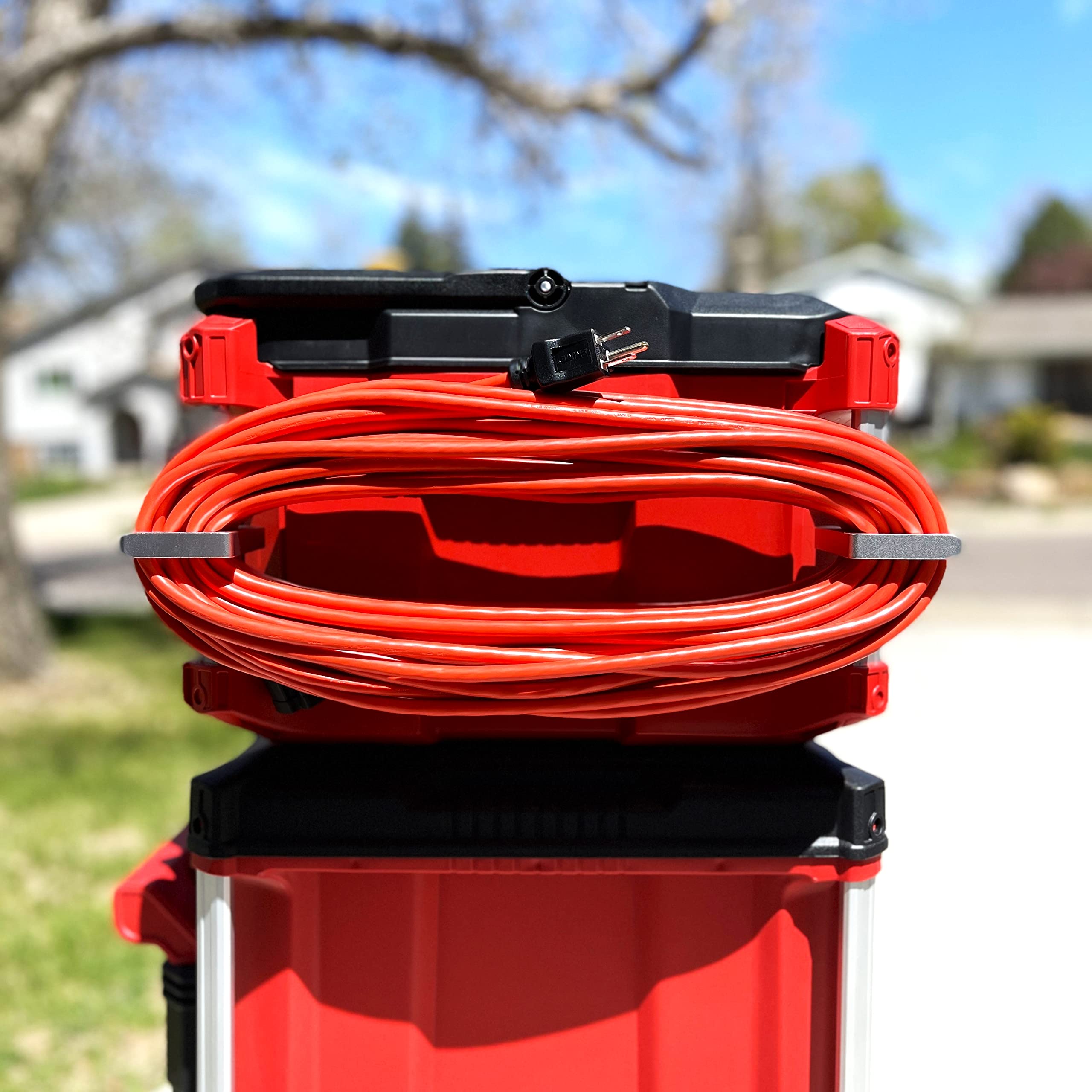 Alpha Engineered Packout Extension Cord Holder in use, keeping cords and hoses neatly accessible.