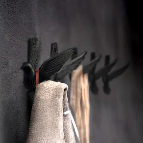 Entryway scene with Ambipolar pigeon hooks organizing coats and hats.