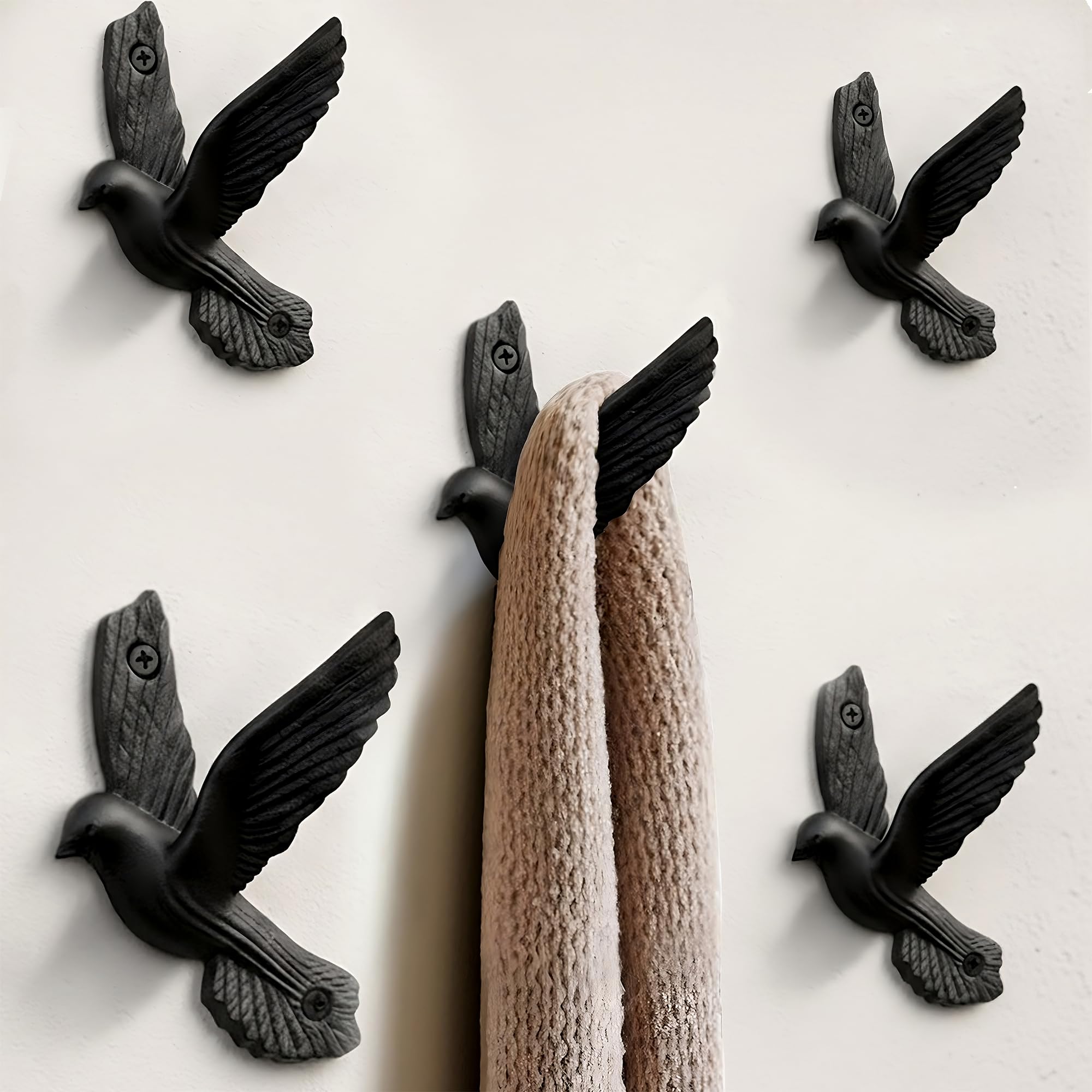 Ambipolar pigeon wall hooks in antique black hold coats and bags with rustic charm.