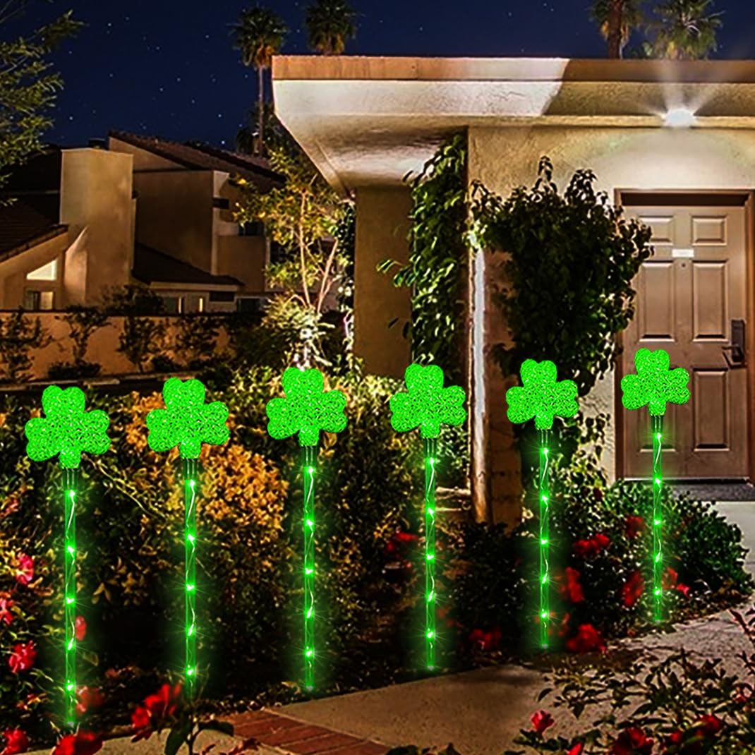 ANLTDTC six pack shamrock lights lined along garden edge for glow