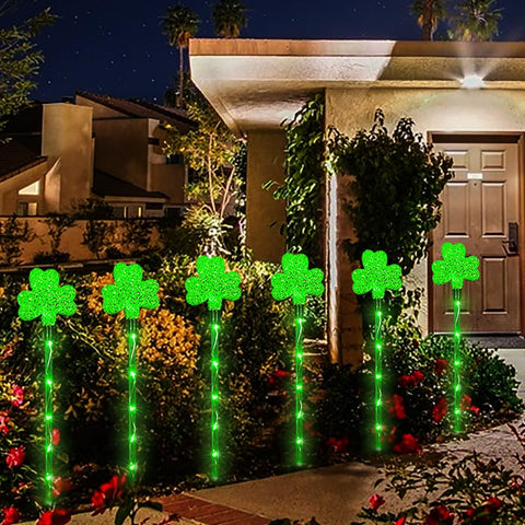 ANLTDTC six pack shamrock lights lined along garden edge for glow