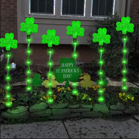 ANLTDTC solar shamrock garden stake light beside a lawn display