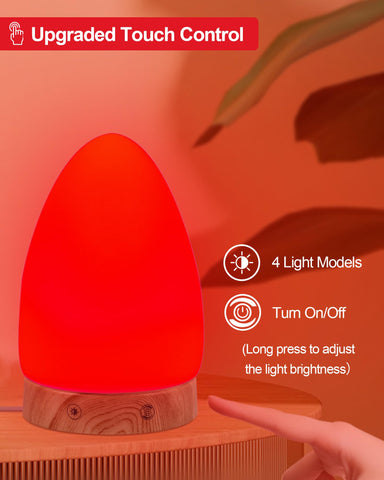 Aoife red light lamp featuring USB charging at the bedside for devices.