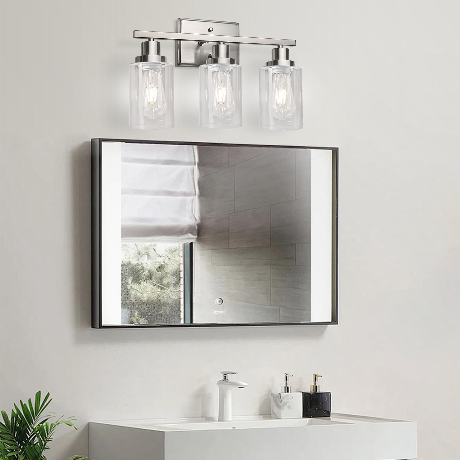 Three-light wall sconce offers broad wall coverage for mirrors or artwork.