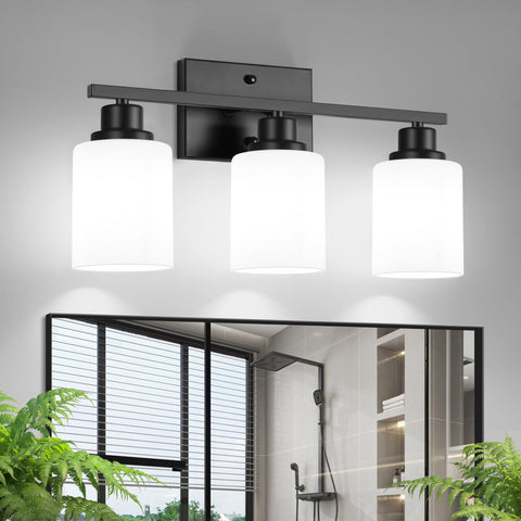 Ascher 3-light vanity fixture in black finish over bathroom mirror for clear task lighting.