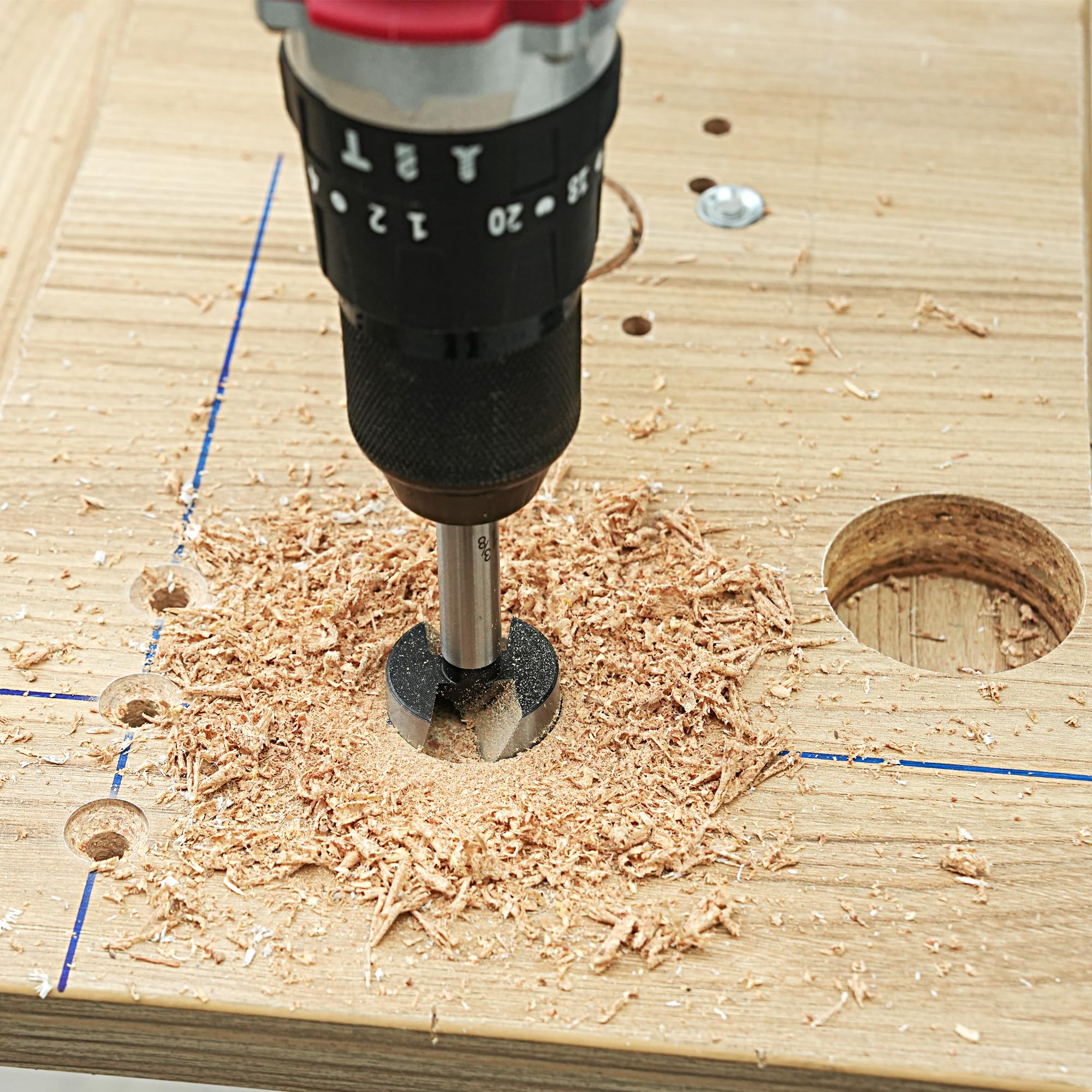 Axelord bit in use on wood to create neat circular pockets.