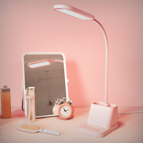 AXX pink desk lamp in a dorm room setup.