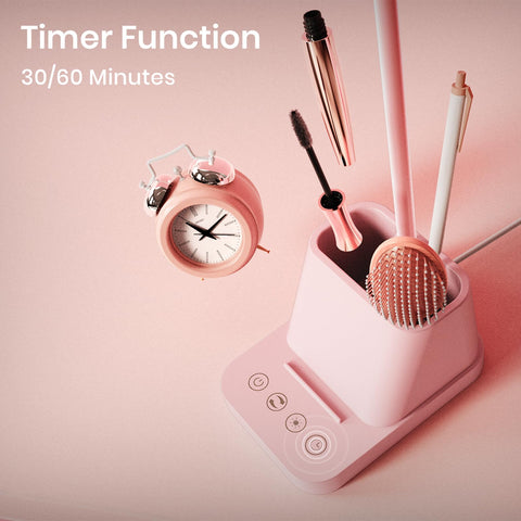 AXX pink desk lamp on desk with phone stand and pencils.