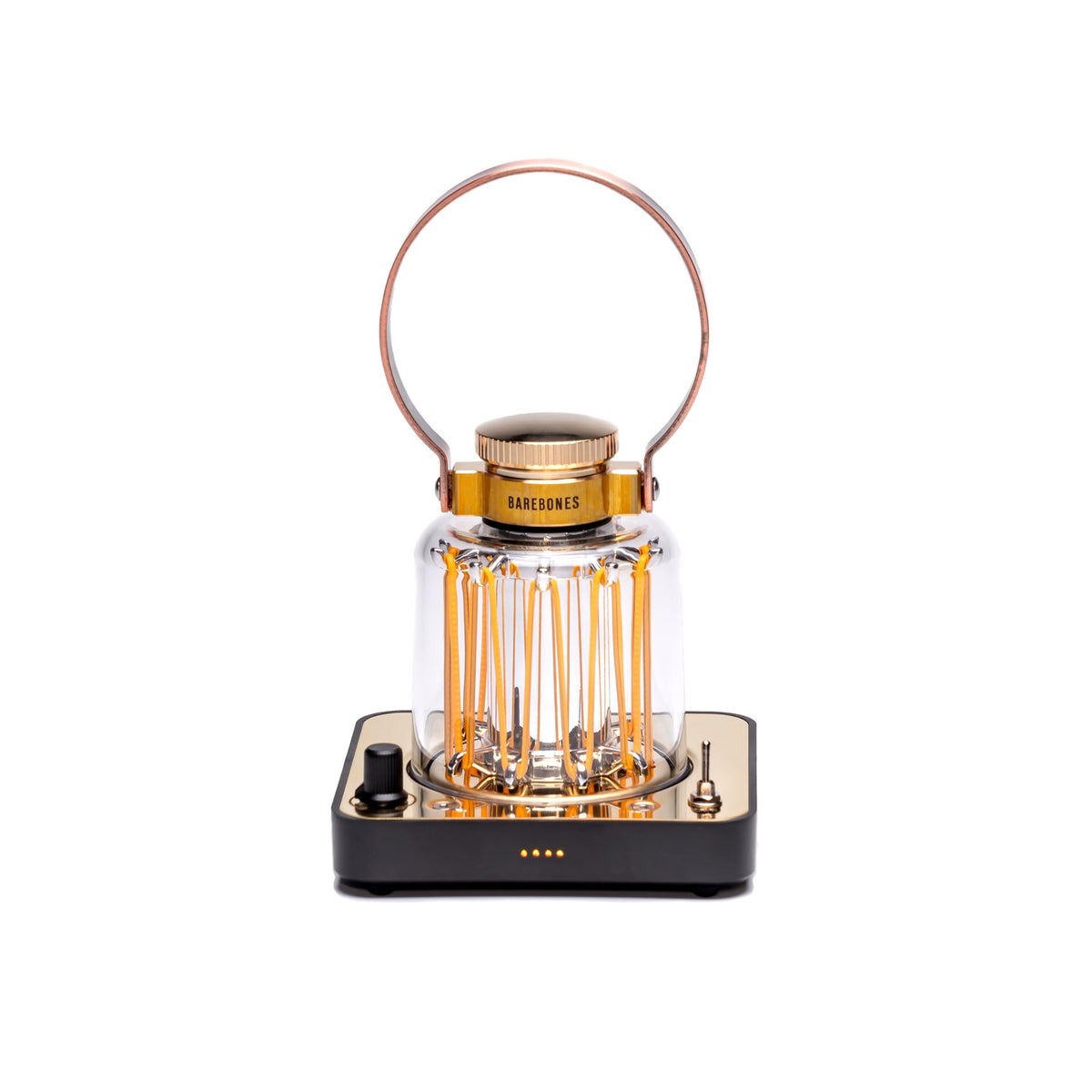 Barebones Block Tower Lantern with brass finish emits warm indoor glow.