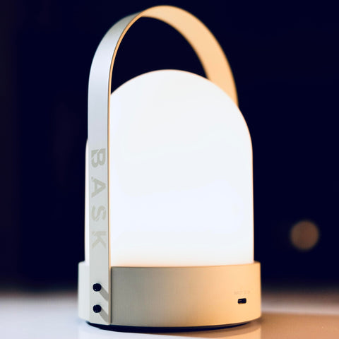 Bask KIN 3.0 cordless lantern on bedside table with warm diffused light