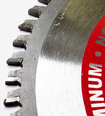 Benchmark Abrasives TCT blade cutting brass with precision results.