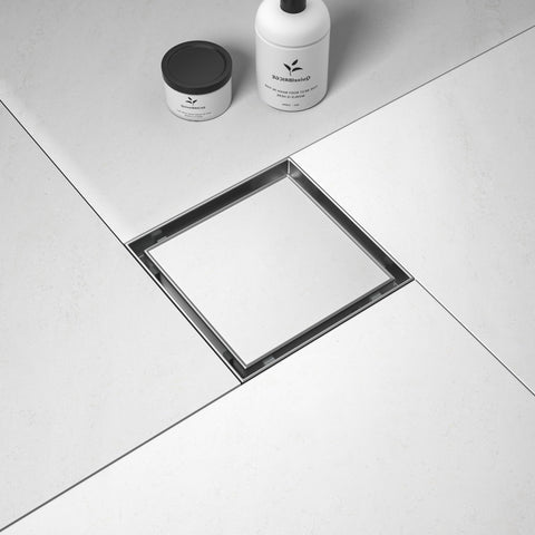 Bernkot square drain with brushed 6-inch outlet for durable bathroom use.