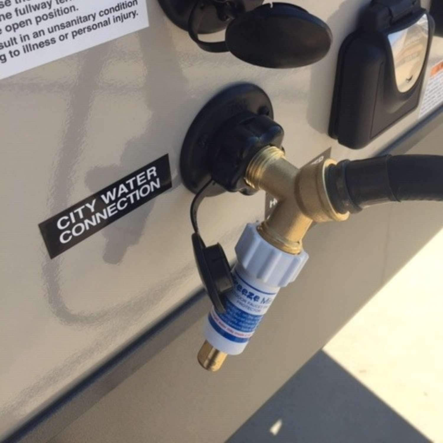 Blue Penguin Freeze Miser in use, protecting outdoor faucet from ice with minimal water.