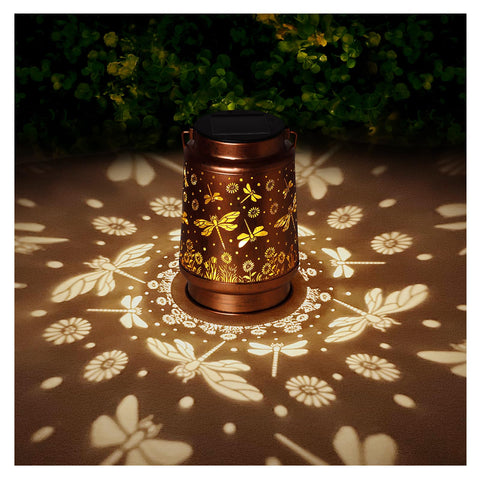 BODEVEDOB solar lantern with dragonfly hanging design illuminates a garden at night.