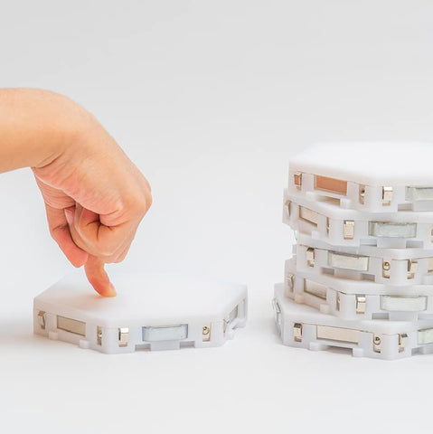 Bright Autism Tap-Tap magnets encourage tactile construction in a cozy sensory corner.