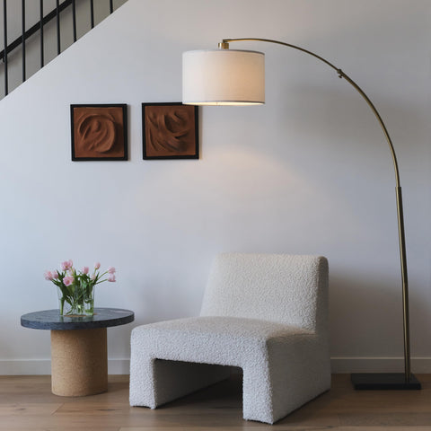 Logan Arc lamp showcases a 44-inch reach for overhead illumination in seating areas