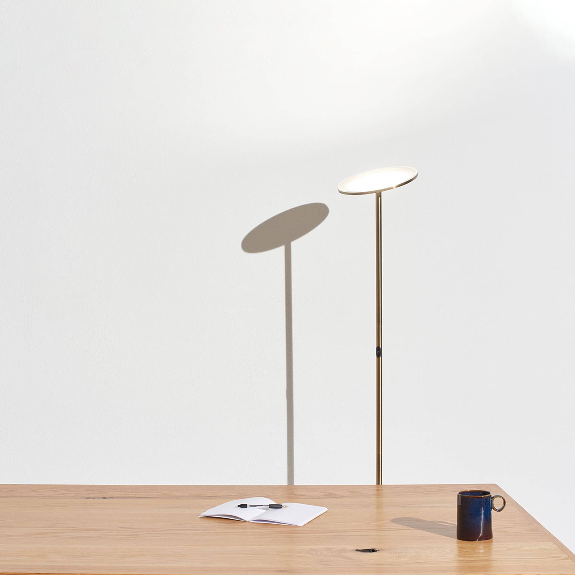Brightech Sky lamp in a bedroom setup for night reading