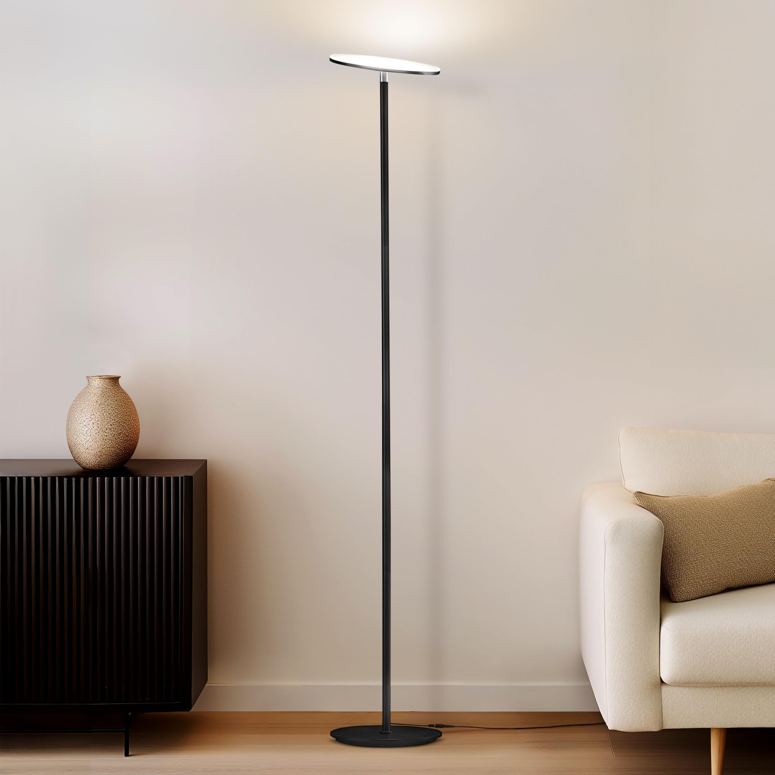 Brightech Sky tall torch lamp in living room provides warm ambient lighting.