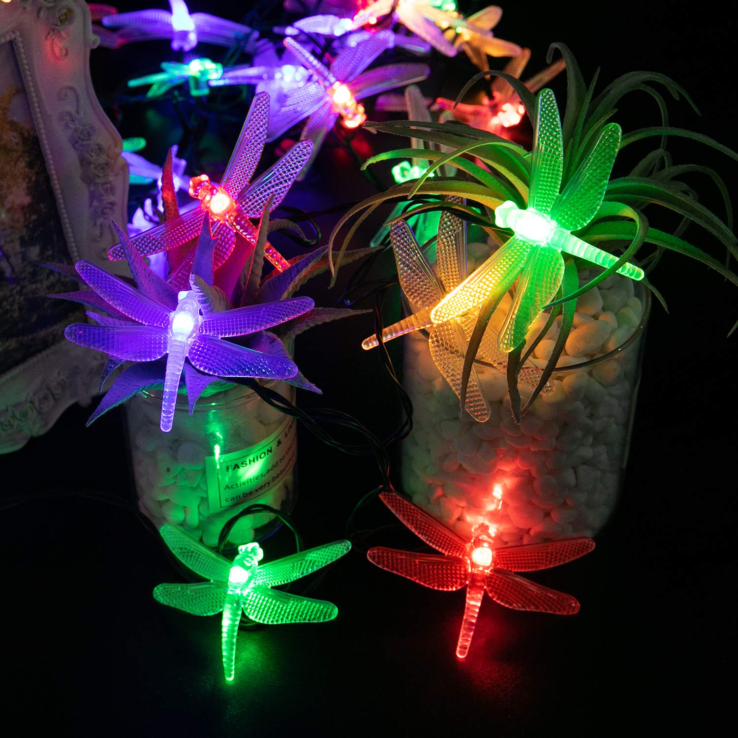 Brightown dragonfly lights along a fence with warm glow