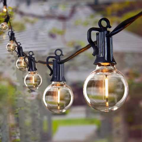 Brightown 69ft outdoor string lights illuminate a patio with warm glow
