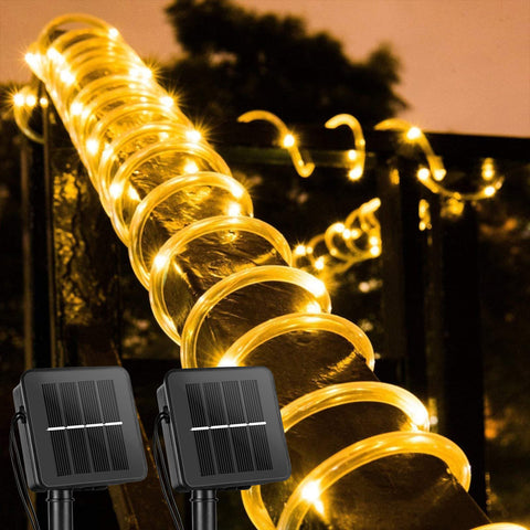 Brightown solar rope lights around a tree creating warm ambient glow.