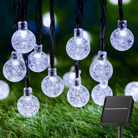 Brightown solar string lights with 60 LEDs glow softly to brighten outdoor evenings.