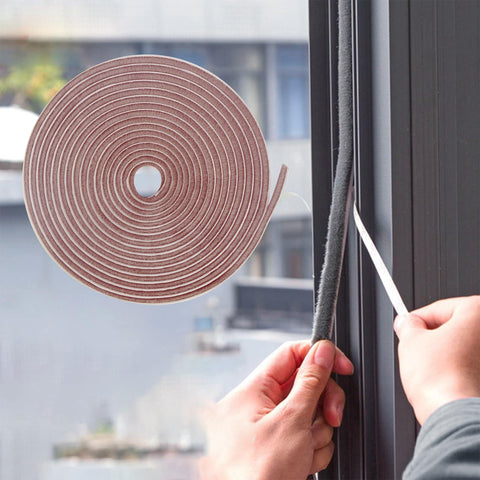 Bruiefpap weather strip adhesive roll in brown seals air gaps to reduce drafts.