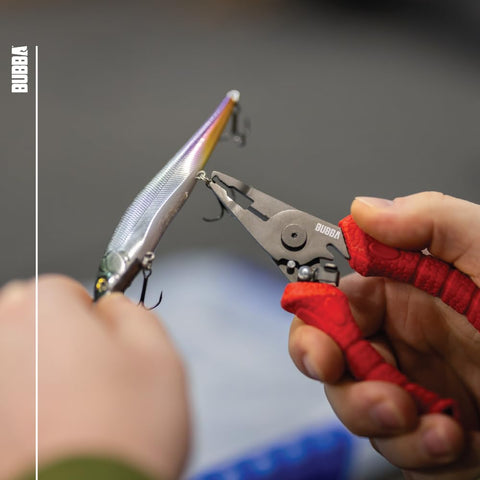 BUBBA spring-loaded mechanism provides one-handed operation during fishing setup.
