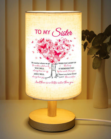 Calibron sister table lamp with wooden stand adds warm ambience to living spaces.