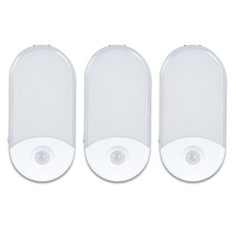 Camelion 3-pack 4-in-1 night light plugged into outlet for safe hallway lighting.