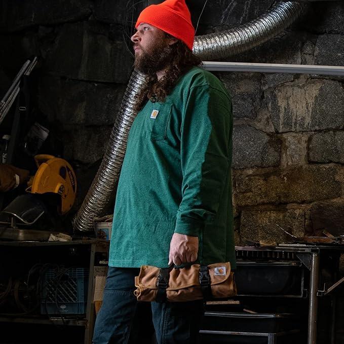 Carhartt rolled-up tool roll with compact size and secure buckle closure.