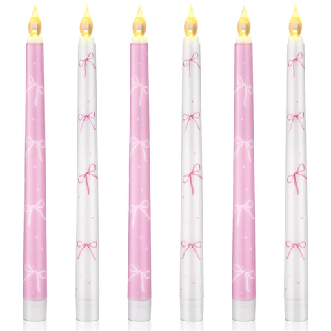Conelist Coquette pink bow flameless taper candle closeup with warm LED glow for romantic ambiance.