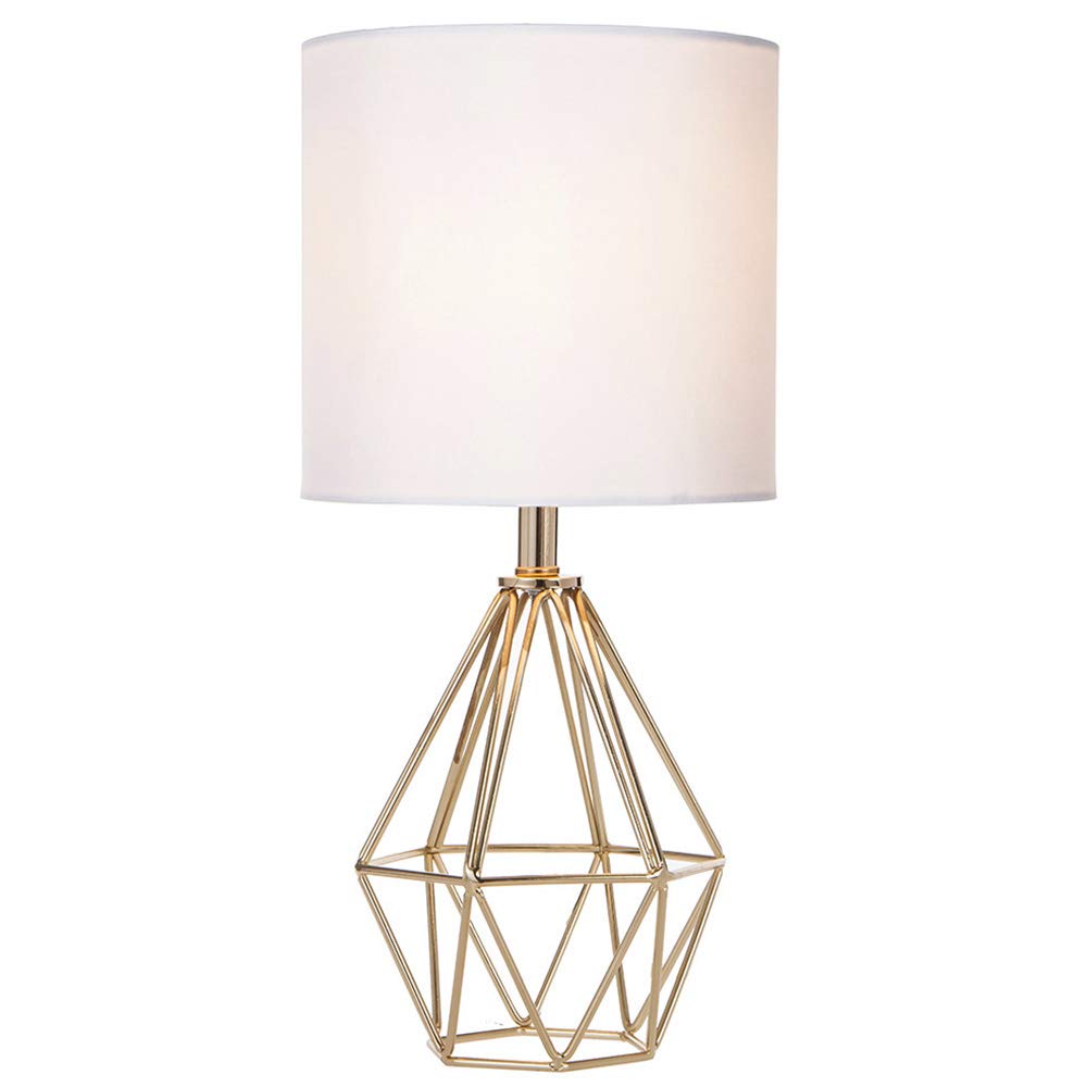 COTULIN gold hollow-base lamp viewed beside the bed for a cozy reading light.