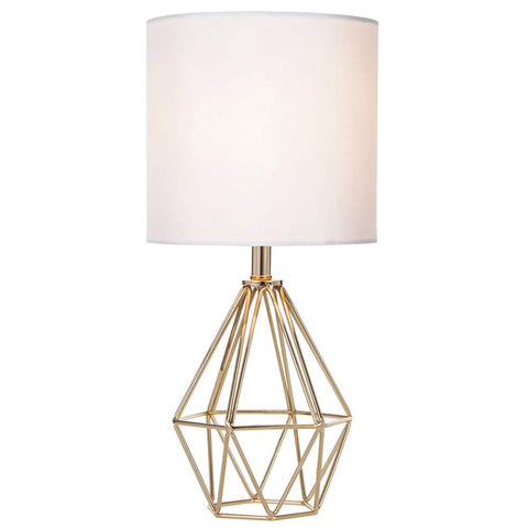 COTULIN gold hollow-base lamp viewed beside the bed for a cozy reading light.